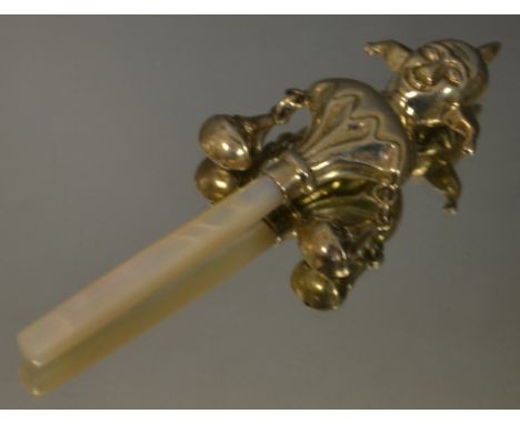 A sterling silver Peridot rattle, with mother of pearl handle