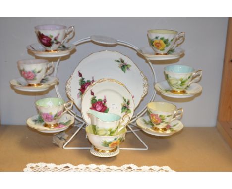 A Royal Standard World Famous Roses pattern tea service for six, designed by Henry Wheatcroft, including cake plate, cups, sa