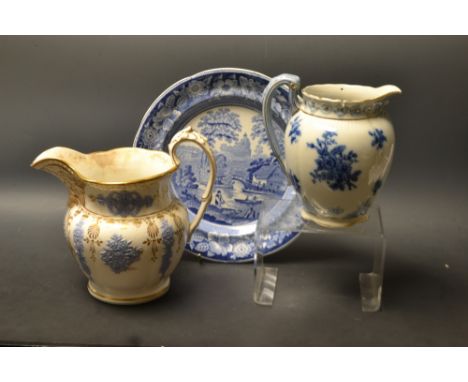An early 19th century relief moulded jug, possibly H & R Daniels, dated 1829; another later Victorian ; a 19th century blue a