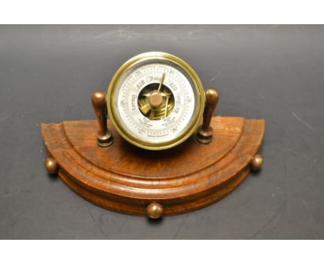 An oak mounted aneroid desk barometer