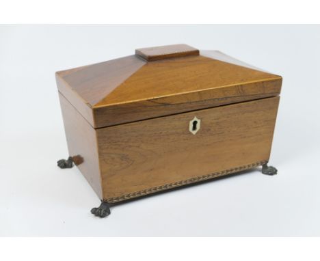 Regency rosewood sarcophagus tea caddy, with twin wooden caddy interiors and hinged covers, raised on brass feet, 25.5cm
