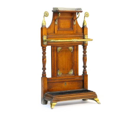 Late Victorian oak and brass hall stand, attributed to James Shoolbred, circa 1880, having a small brass galleried shelf over