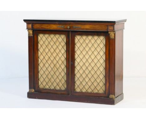 Regency rosewood side cabinet, having a black marble top over a long frieze drawer and two carved gilt capped pilasters flank