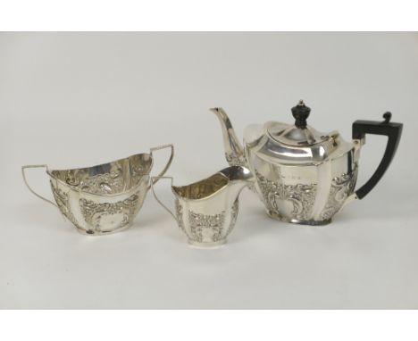 Edwardian silver three piece bachelor's tea service, Birmingham 1904/05/06, comprising a fluted oval section teapot with repo