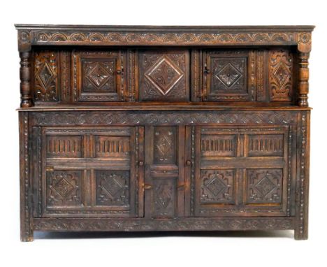 Carved oak joined court cupboard, third quarter 17th Century with some later alterations, having a carved lunette frieze over