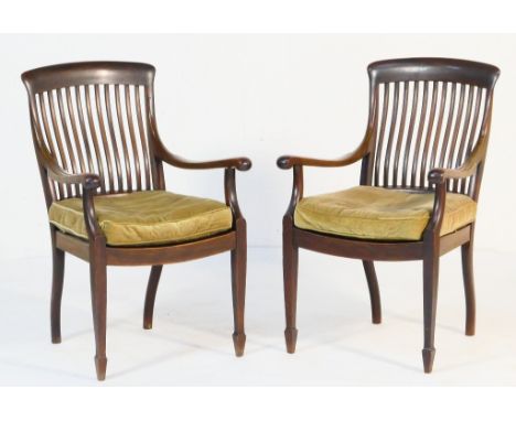 Pair of George V mahogany comb back armchairs, each having a green fabric covered cushion over a string seat, tapered square 