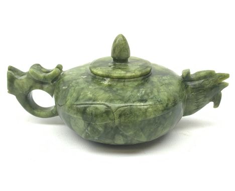 A carved jade teapot, the spout modelled as the head of a bird, the handle modelled as a stylised dragons head, H7.5cm.  - Co