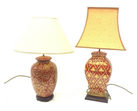 A table lamp of ovoid form, the red ground with gilt foliate decoration, with shade, lamp H45cm, together with a similarly de