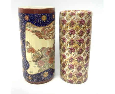 Two ceramic stick stands, the first Oriental example detailed with phoenix and flowers within a blue and gilt detailed border