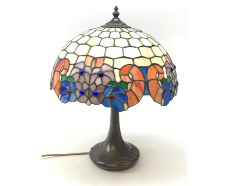 A Tiffany style table lamp, with cast spreading base detailed with tendrils, and leaded glass shade, overall H50cm. - Conditi