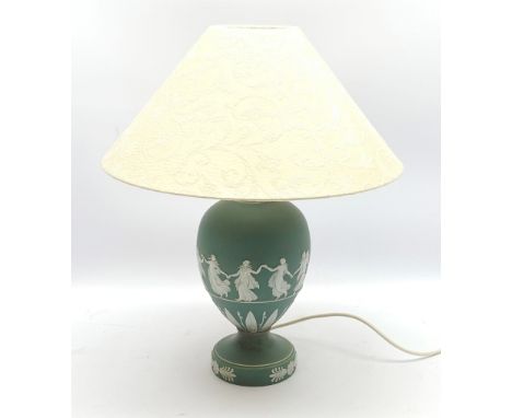 A Wedgwood green Jasperware table lamp, of ovoid form upon a spreading circular foot, decorated with dancing hours, with crea