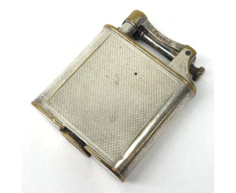 A Dunhill silver plated cigarette lighter, with engine turned panels to the body, marked to arm Dunhill Reg No 737418, marked