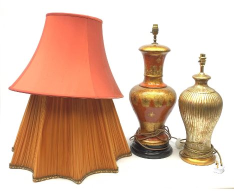 A large table lamp, of baluster form the red ochre ground with gilt foliate detail, with shade, lamp H63cm, together with a g