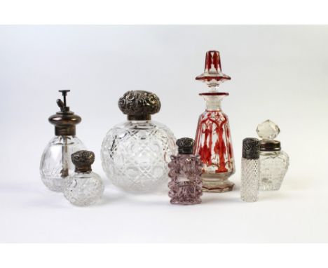 Cut glass and crystal perfume and scent bottles, some with silver collars 