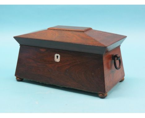 An early 19th century rosewood tea caddy, sarcophagus-shape with enclosed canisters and mixing division, 13in. 