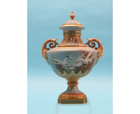 A Royal Worcester jar and cover, painted by Charles Baldwyn, squat pedestal form finely painted with swans in flight and gild