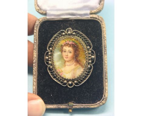 A fine Russian portrait miniature brooch, attractive young female wearing floral head-dress, painted on pearl-shell, Russian 