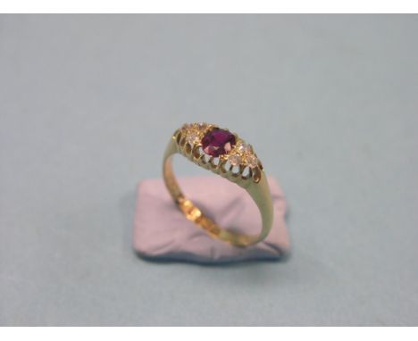 An Edward VII 18ct. gold half-hoop ring, central ruby and diamond chips in claw setting, size Q/R, London  1905 