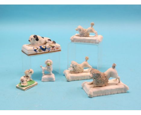 Victorian ceramic dog models, including group of three bisque models on cushion plinths, six total