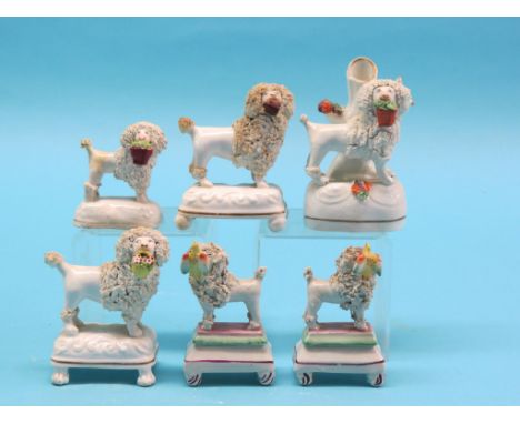 A pair of Victorian ceramic dog models, each holding bird, and four other similar dog models, one tail repaired