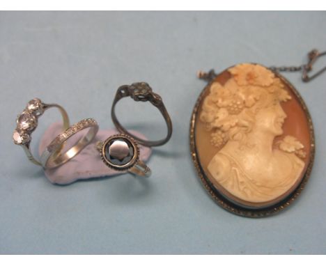 A white metal and diamond half-eternity ring, haematite dress ring, two other rings and a carved cameo portrait brooch 