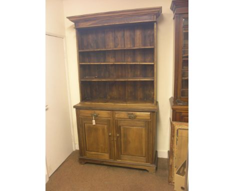 A late Victorian beech dresser, three-shelf plate rack above panelled cupboard base with two drawers, 4ft. wide