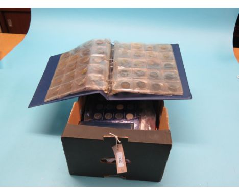 A quantity of vintage and commemorative coins, an album, gift sets and loose