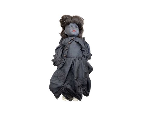 An interesting Kammer and Reinhardt bisque head doll, solid body colour, in gothic-style gown. Marked to back of head K&amp;R