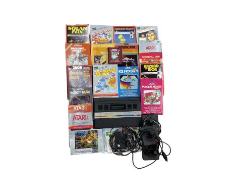 An Atari 2600 console with 3 joysticks, power cable, and a large selection of games.