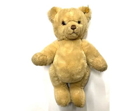 A modern Steiff teddy bear, with gold Steiff button and yellow label to ear.