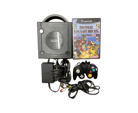 A Nintendo Gamecube console, with accessories to include: - Gamepad - Power supply - AV connector - Games: Mario Kart / Starf
