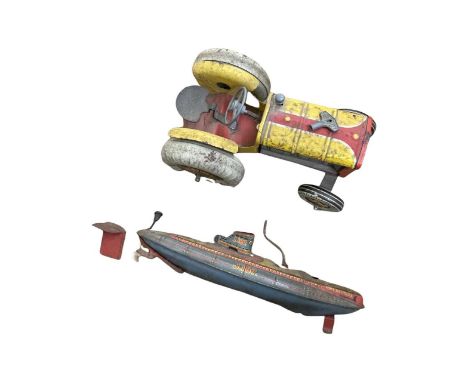 A pair of tin-plate clockwork toys, to include: - A Met Toy tractor with key - A lonboat marker J187 HMS Nautilus (af)