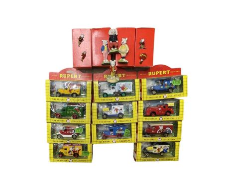 A mixed lot of Rupert the Bear collectable models and toys, to include: - Various boxed die-cast vehicles - 4 boxed hand-pain