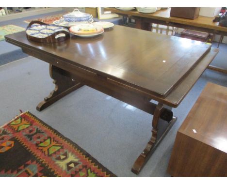 A dark Ercol extending dining table 30" h x 54", together with six matching chairs 