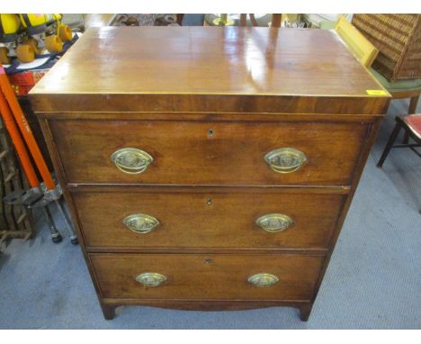 An early 19th century mahogany chest of three long drawers, standing on shaped bracket feet 
