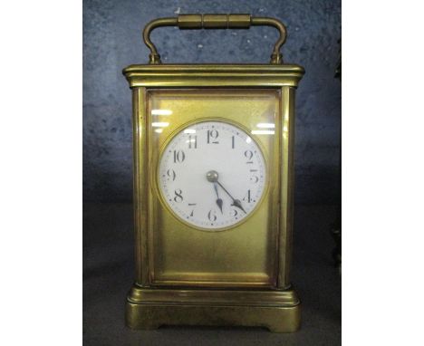 A late 19th/early 20th century French brass carriage clock having white enamel dial with Roman numerals A/F missing back door