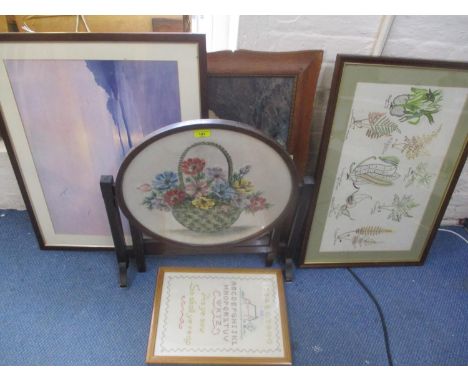 An early 20th century oak folding firescreen/occasional table, together with two embroideries and two prints 