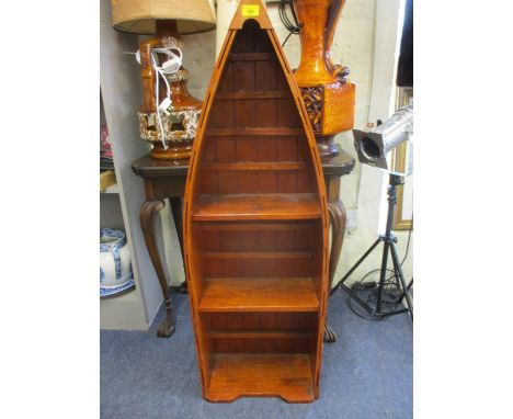 A contemporary wall shelf in the form of a boat, together with a small pie crust occasional table in oak with barley twist su