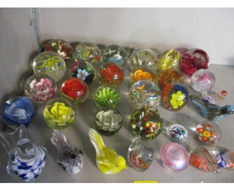 A collection of glass paperweights to include a Caithness 40th celebration example, an Eirian example and millefiori 