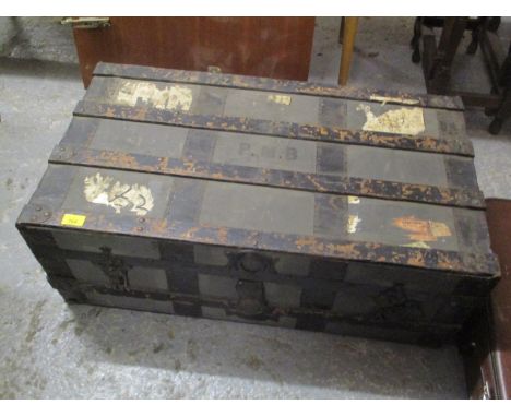 An early 20th century metal bound, twin handled trunk 