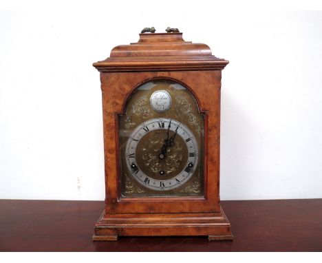 An early to mid 20th Century burr walnut bracket clock, brass arched dial with engraved spandrel decoration, silvered Roman c