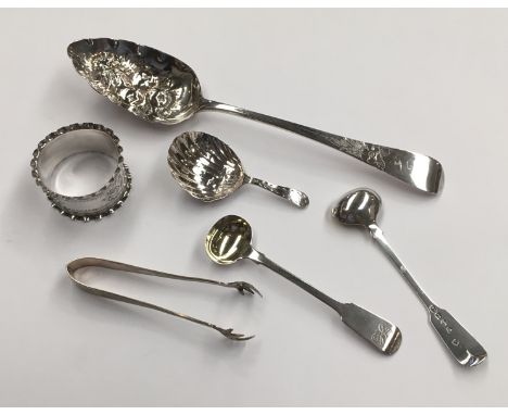 A Georgian silver berry spoon, a pair of salt spoons, a caddy spoon of shell-form, a napkin ring and sugar nips.  (6)