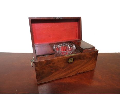 An early 19th Century flame mahogany tea caddy with two tea compartments and glass mixing bowl, 30cm long