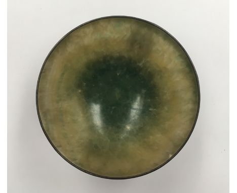 A Chinese jade bowl with white metal mounts and dragons, 11cm diameter  