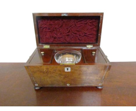 An early 19th Century mahogany tea caddy of sarcophagus form with mother-of-pearl stringing, squashed bun feet