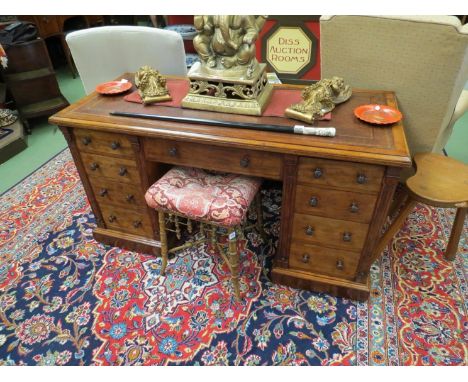 Circa 1860 in the manner of 'Jas Shoolbred' a walnut twin pedestal desk the tooled leather writing surface over nine drawers 