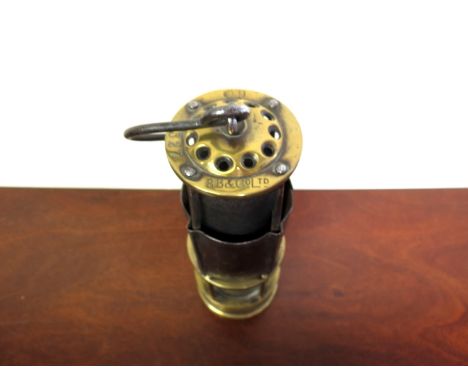 A brass and steel miner's lamp, gauze protected by a movable half-bonnet, top with holes and stamped B.B & Co LTD, unusual