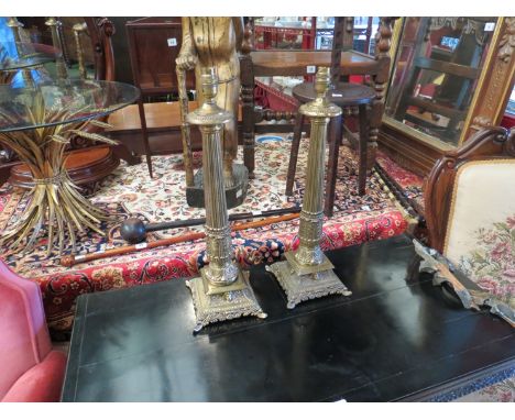 A pair of ornate brass table lamp bases, acanthus leaf decoration on stepped square base with mask detail, 54cm tall