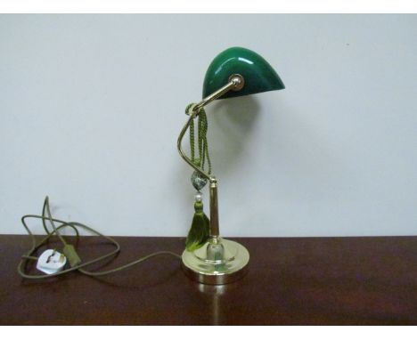 A modern brassed banker's lamp with green glass shade