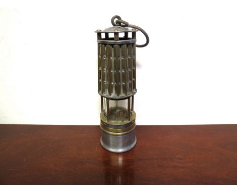 A brass and steel miner's lamp with corrugated brass bonnet 